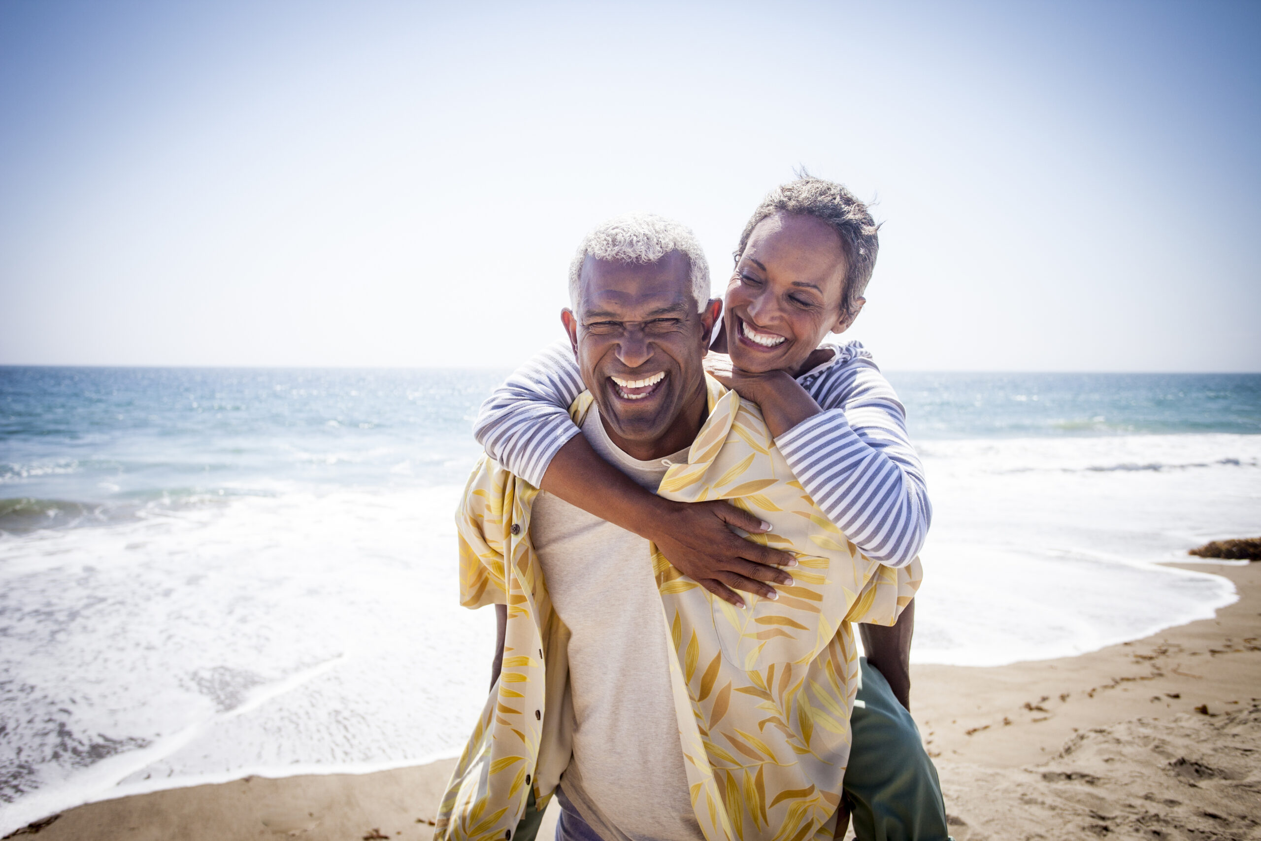 Couple Piggyback on Beach