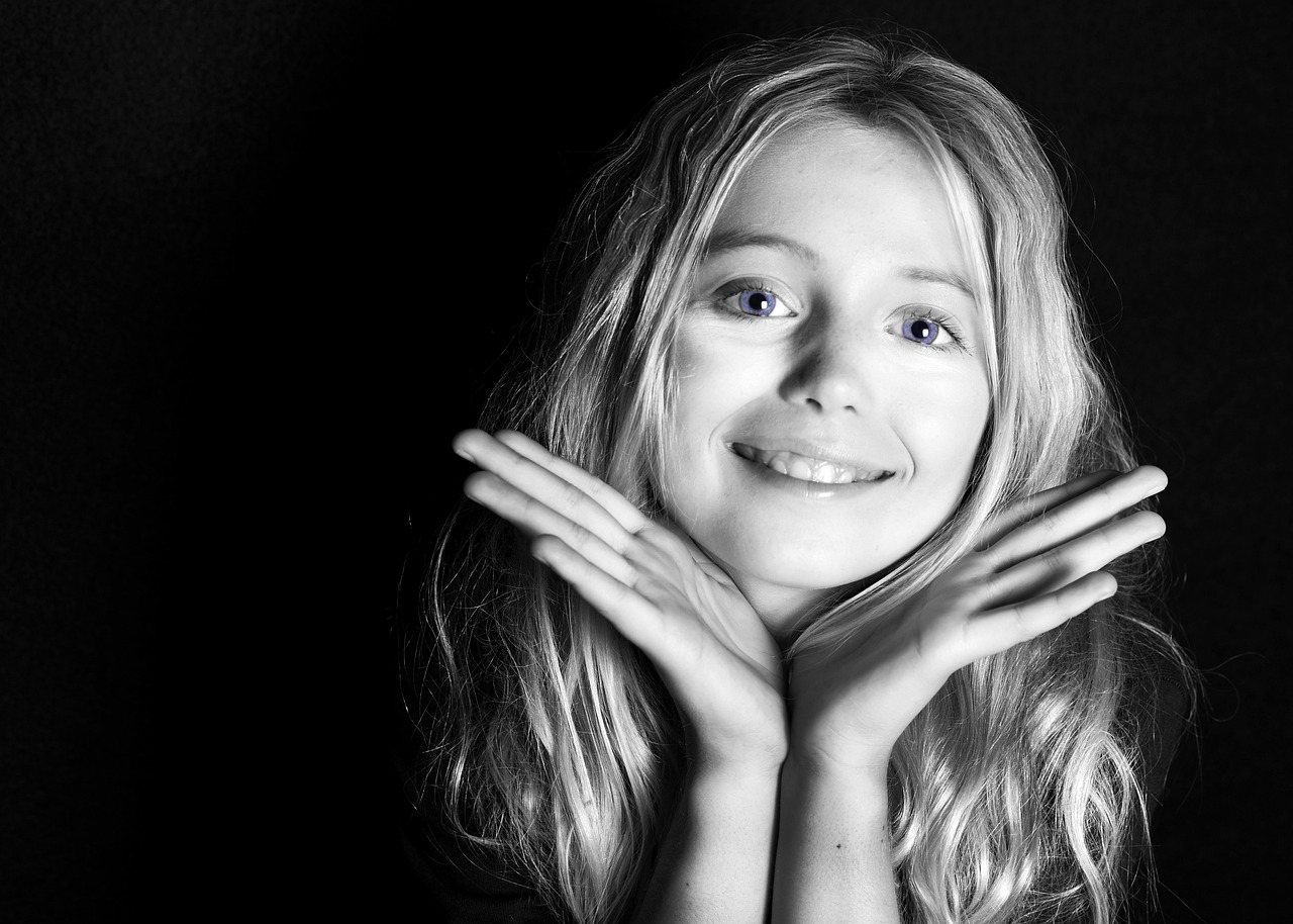 young girl smiling in black & white